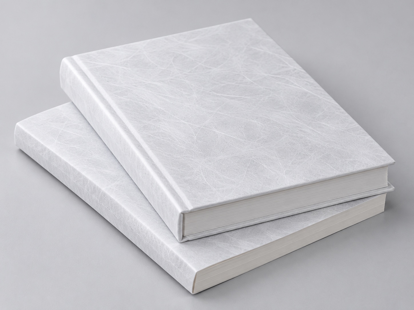 Books with white flashspun HDPE protective covers