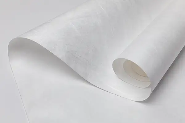 White flashspun HDPE sheet loosely curled from a roll